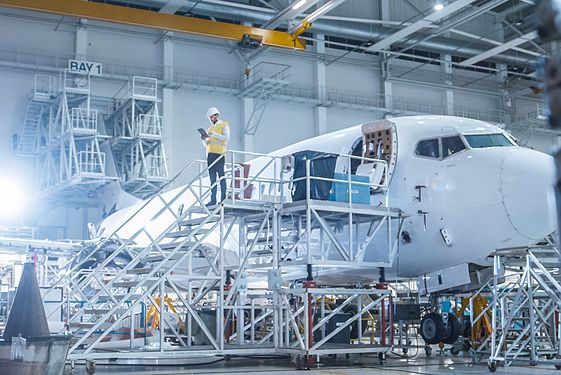 Man standing on latter to plane in equipment room