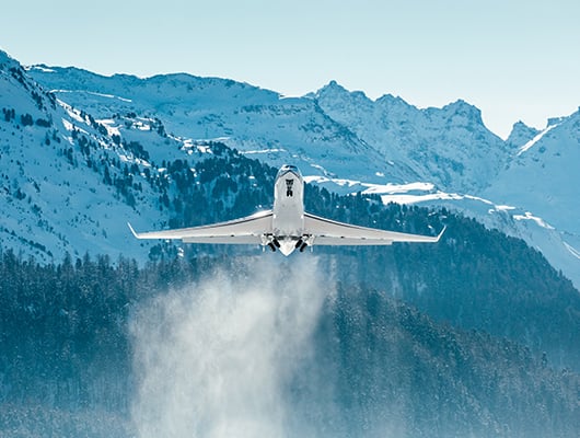 plane taking off in snowy weather