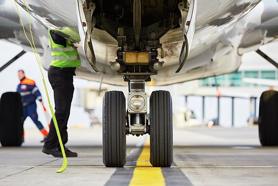 Worker reaching into engine 